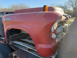 Close-up of a red piece of farm equipment with '6400' on it, likely a tractor fender.