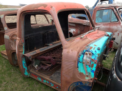 Rusted Chevy Cab With Teal Doorways